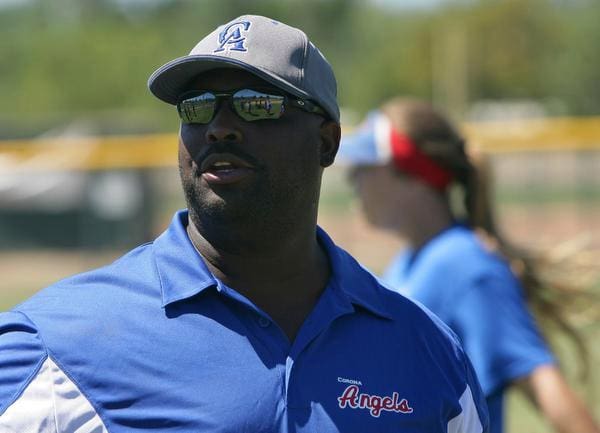 Marty Tyson, coach of the Corona Angels 18 Gold softball team, speaks to his team during the start of practice on Tuesday, July 22, 2014 at Butterfield Park in Corona.