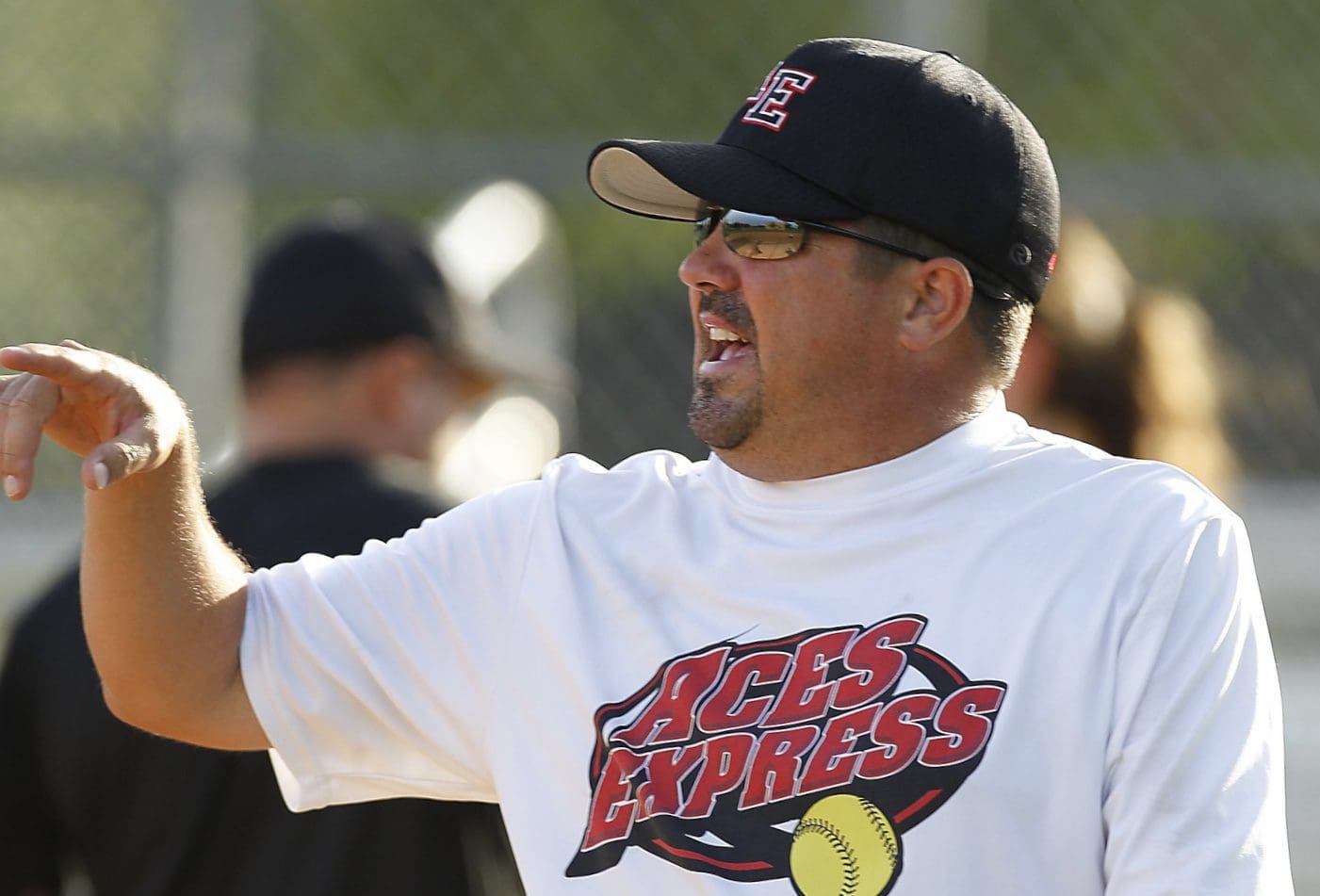 Head coach David McCorkle gives the team some instructions during the Aces Express Gold 18 and Under softball team afternoon practice in Sugar Land, TX on July 10, 2014.