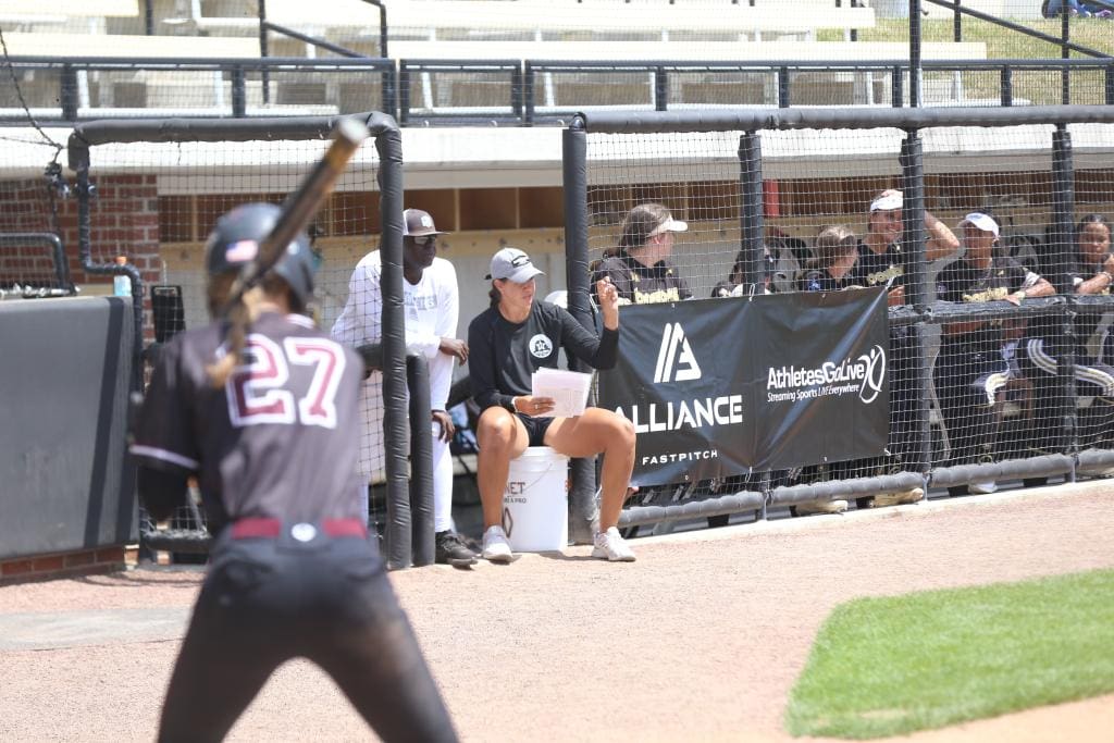 Pitching coach giving signs from the dugout